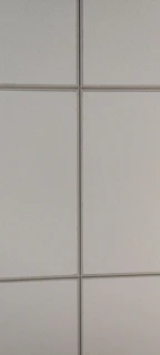 Close-up of custom-manufactured ceiling tiles being inspected in the factory.