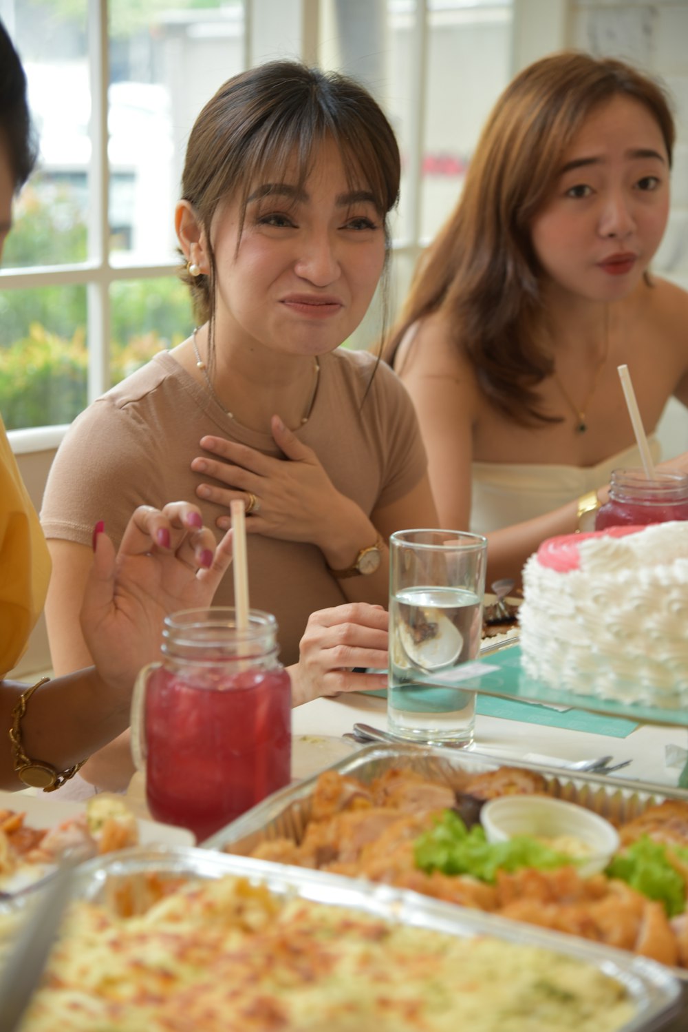 a group of people sitting around a table with food