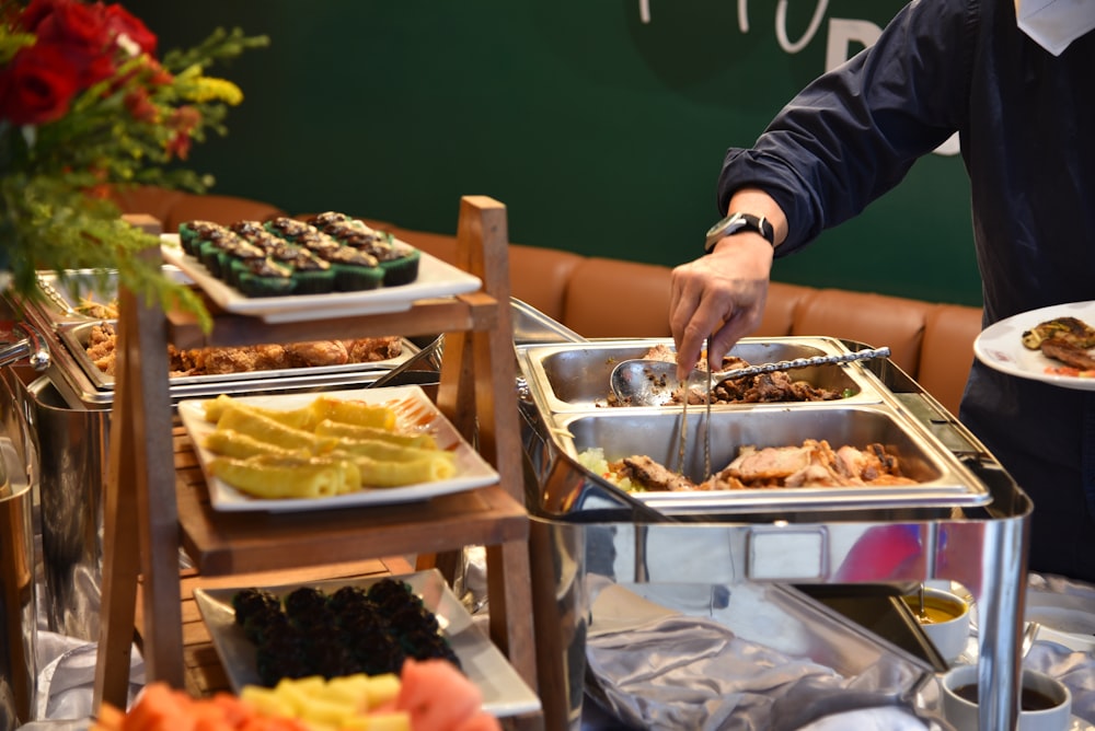 a man is serving a buffet of food