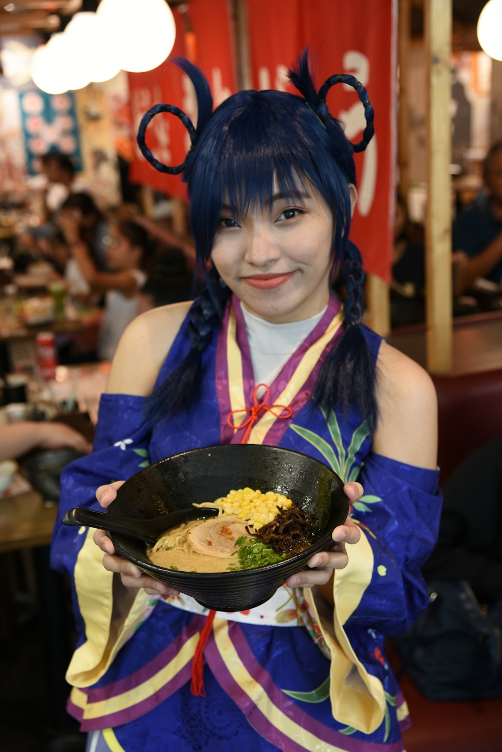 a woman in a costume holding a bowl of food
