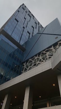 A sleek office building facade with geometric patterns reflecting Middle Eastern design.