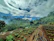 Wide photo of a terraced garden with neat drip irrigation systems along slopes and lush plants thriving.