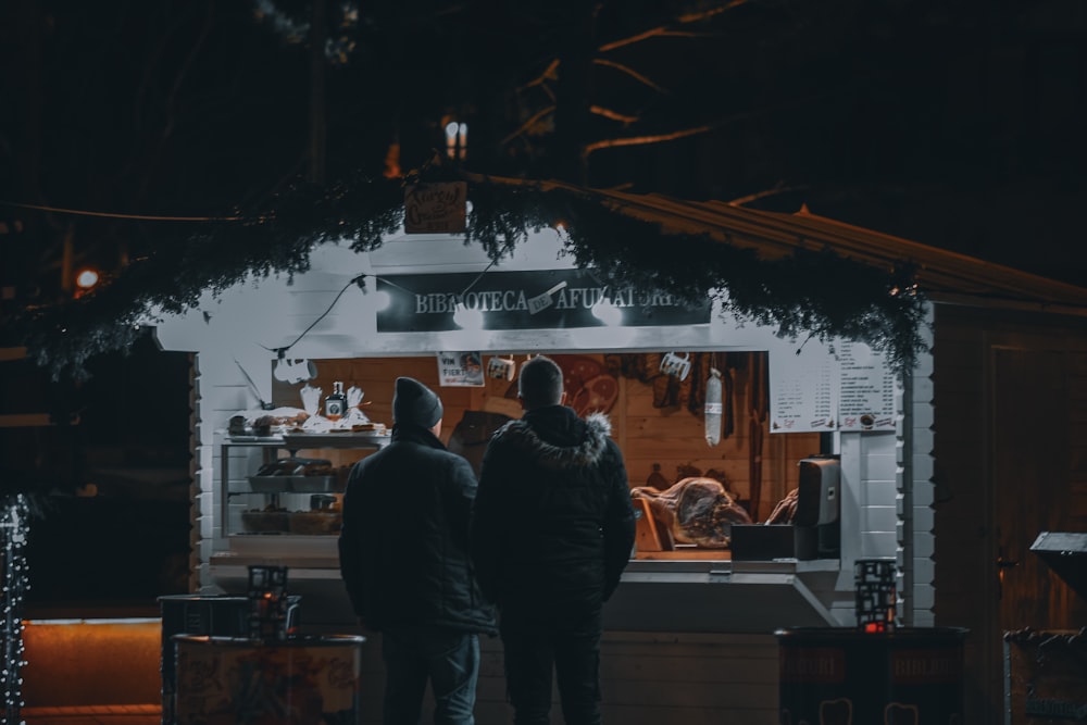 a couple of people standing outside of a building