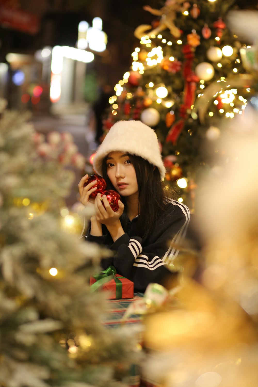 a woman in a santa hat looking at a present