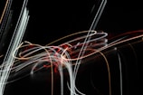An abstract representation of technology and creativity merging through colorful light trails.