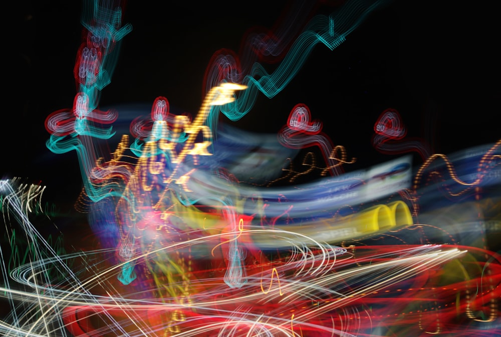 a blurry photo of a carnival ride at night