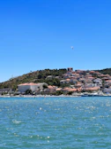 Seagulls soaring above the boat as it sails past the iconic colorful houses of La Spezia’s coastline.
