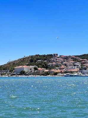 Seagulls soaring above the boat as it sails past the iconic colorful houses of La Spezia’s coastline.