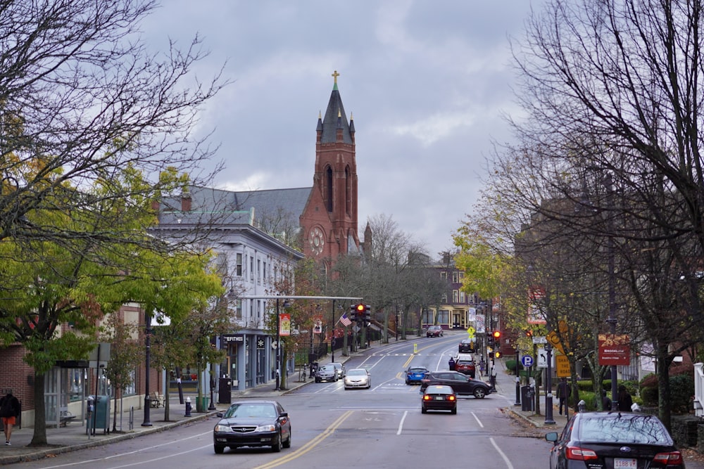 a city street with a church steeple in the background