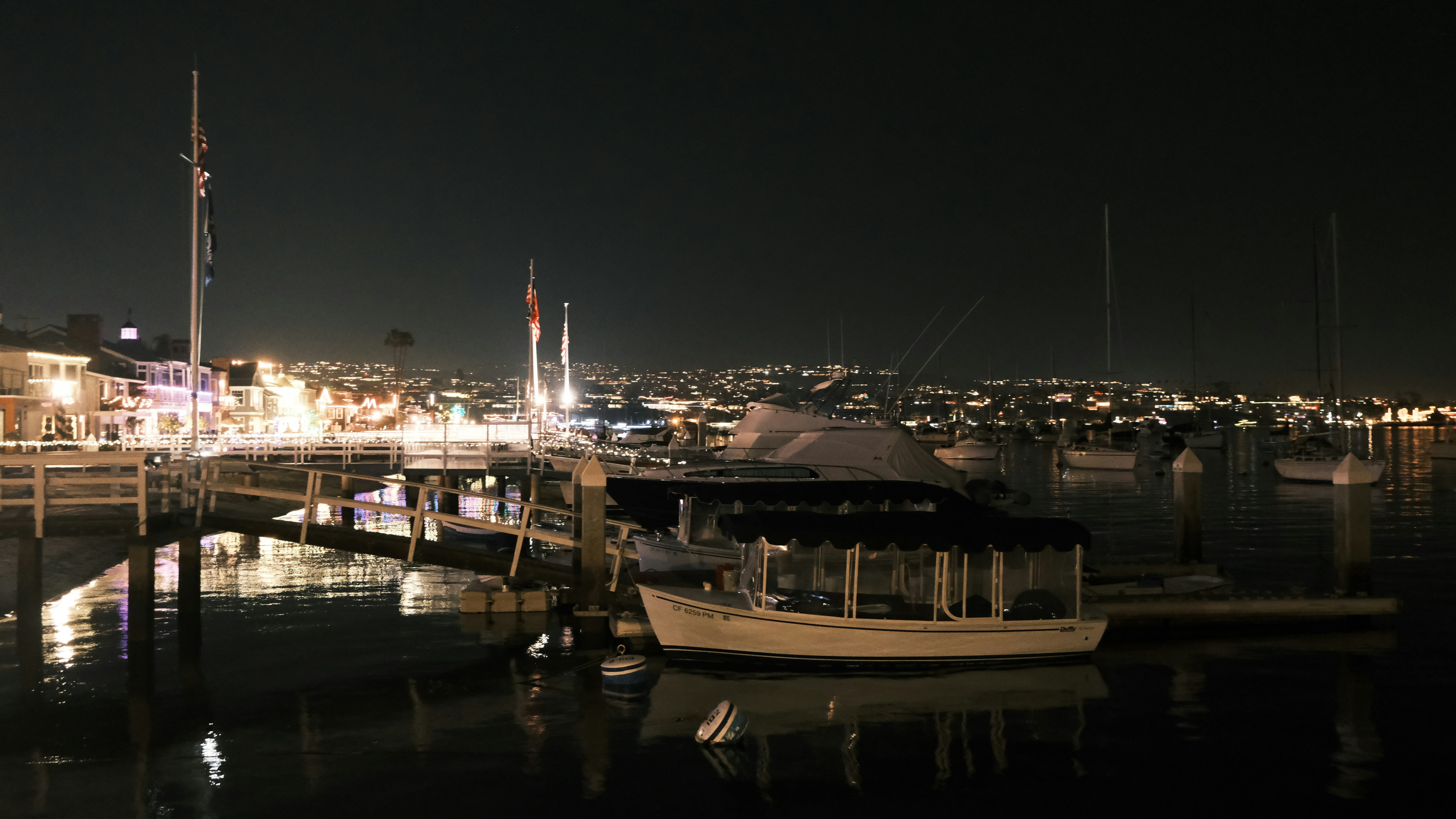 a boat docked in a harbor at night