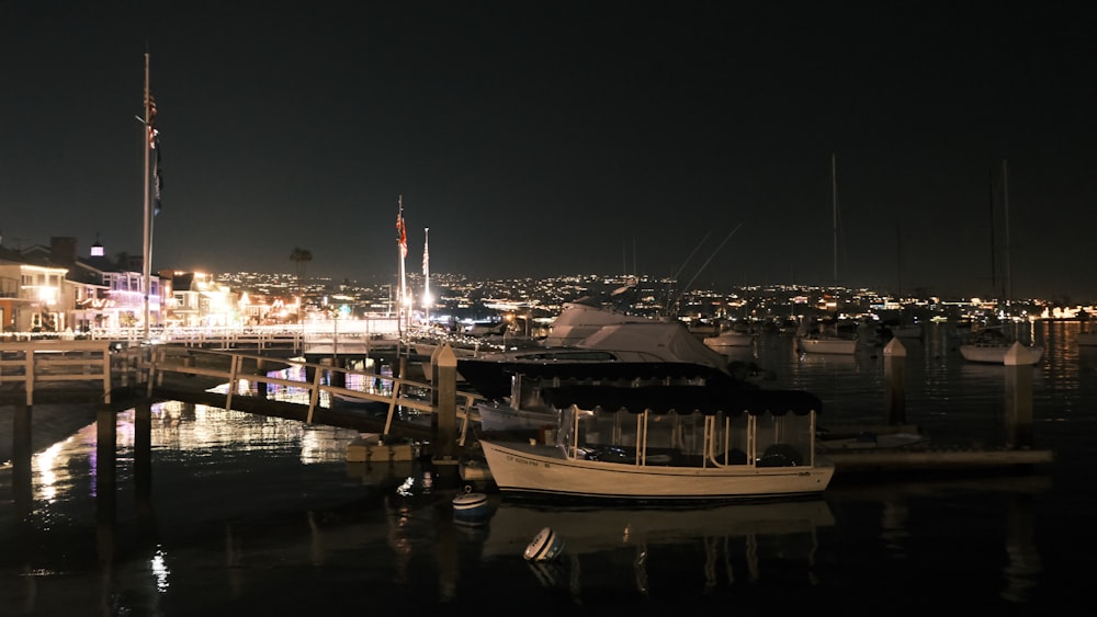 a boat docked in a harbor at night