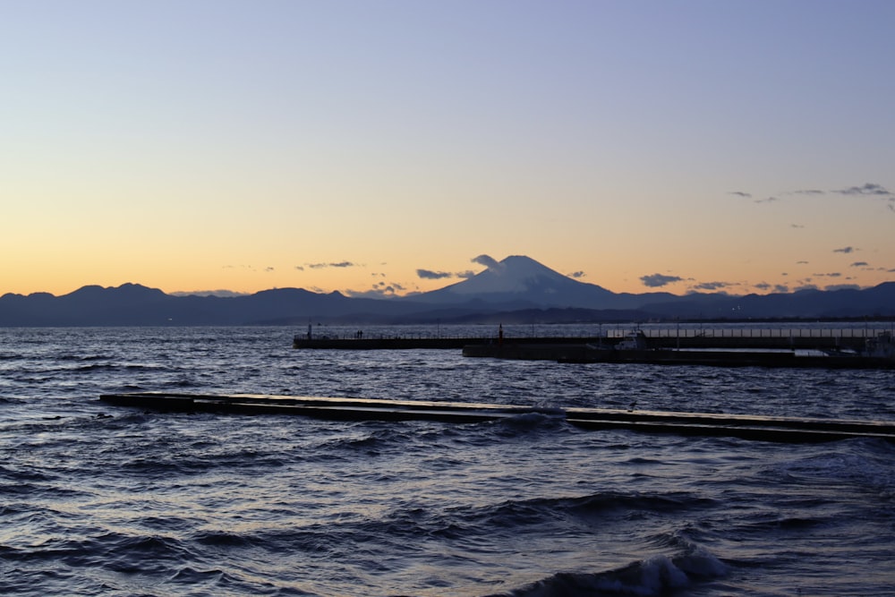 a body of water with a mountain in the background