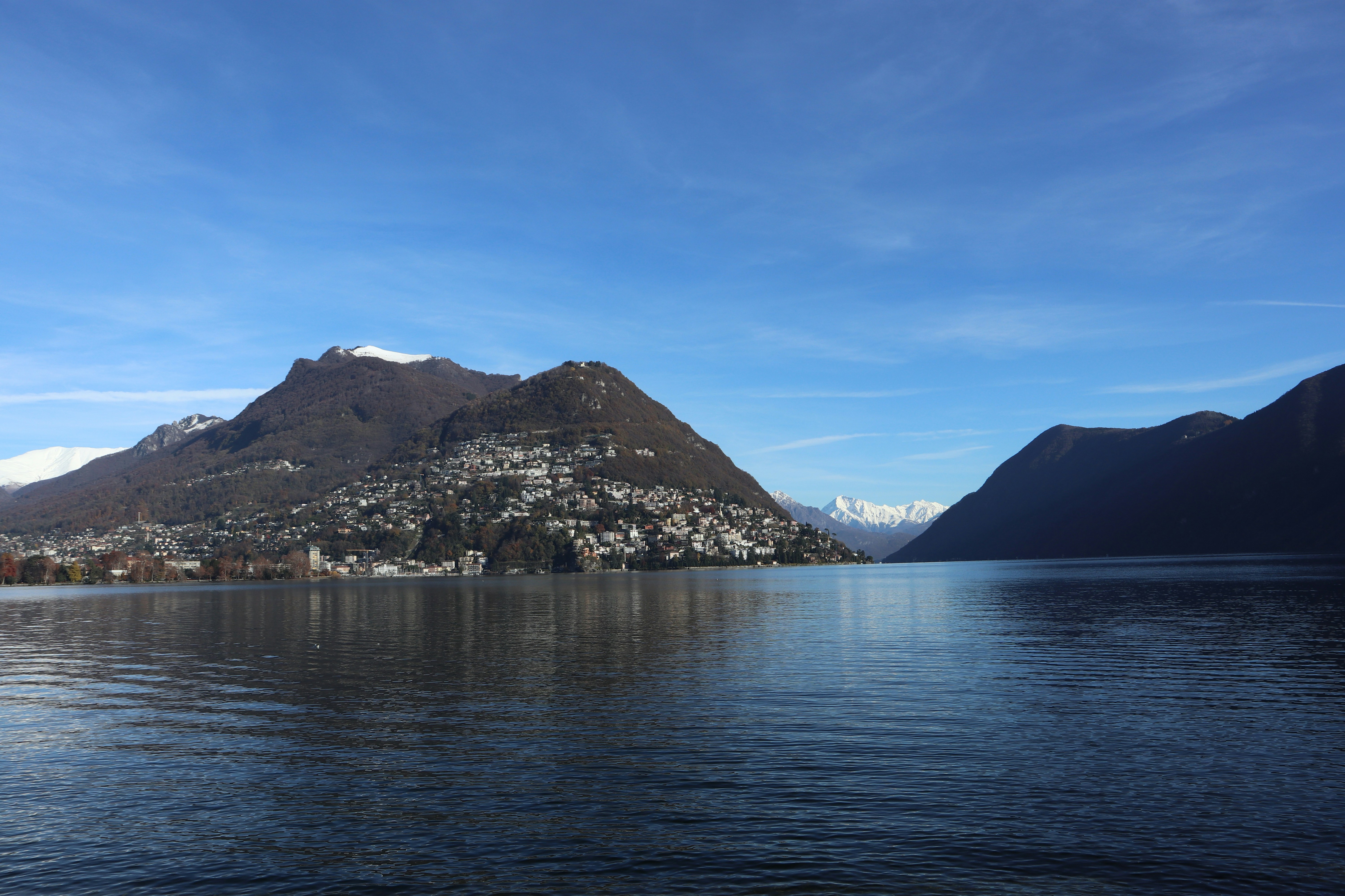 a body of water with mountains in the background