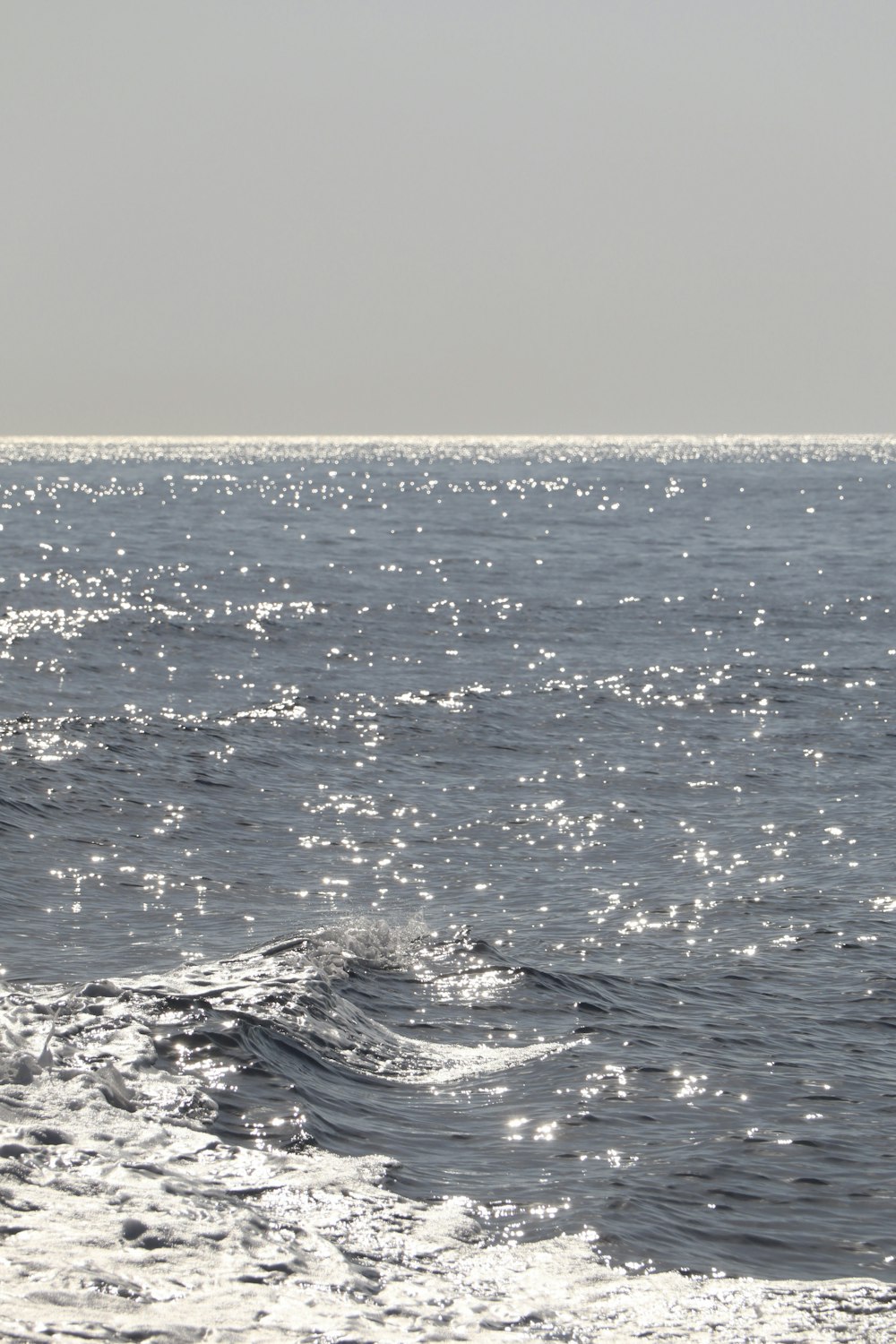 a person riding a surfboard on a large body of water