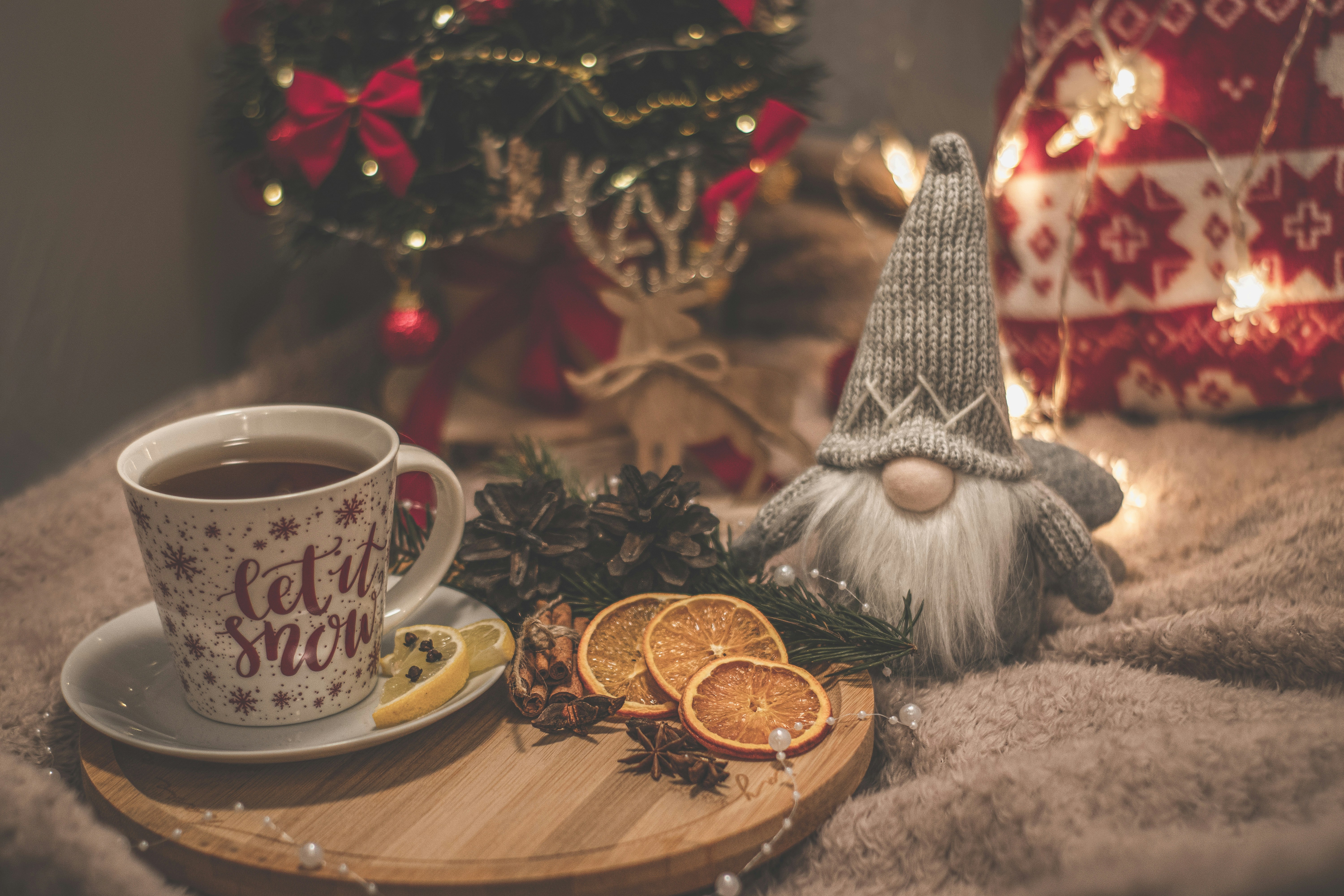 a cup of coffee and a small gnome figurine on a tray