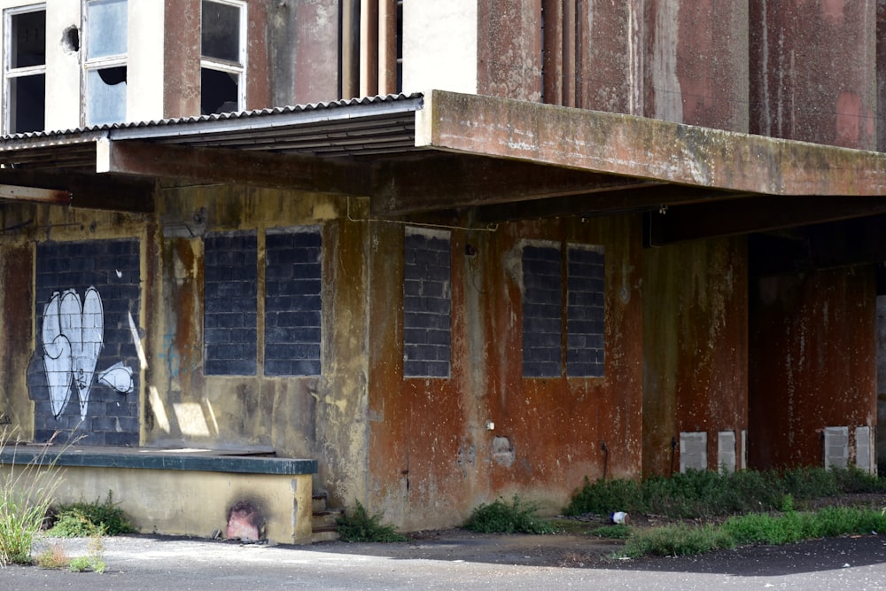 a run down building with graffiti on the side of it