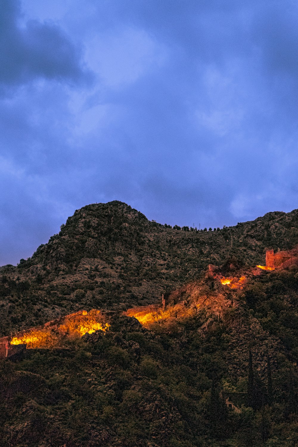 a mountain with a clock tower on top of it