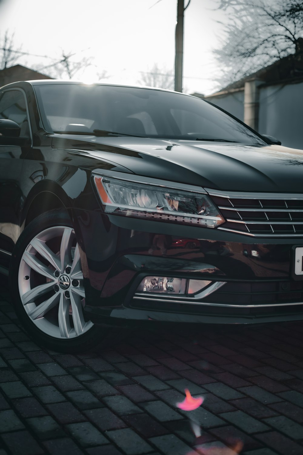 a black car parked on a brick road