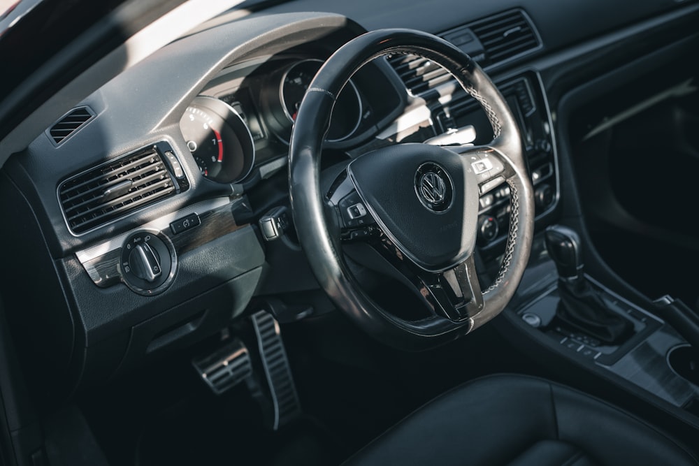 the interior of a car with a steering wheel and dashboard