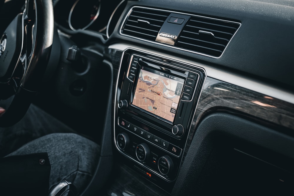 a car dashboard with a gps and a steering wheel