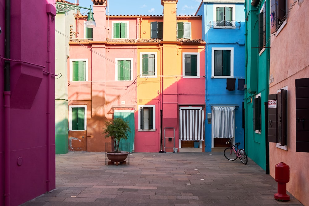 a narrow alley way with colorful buildings and a bicycle parked in the alley