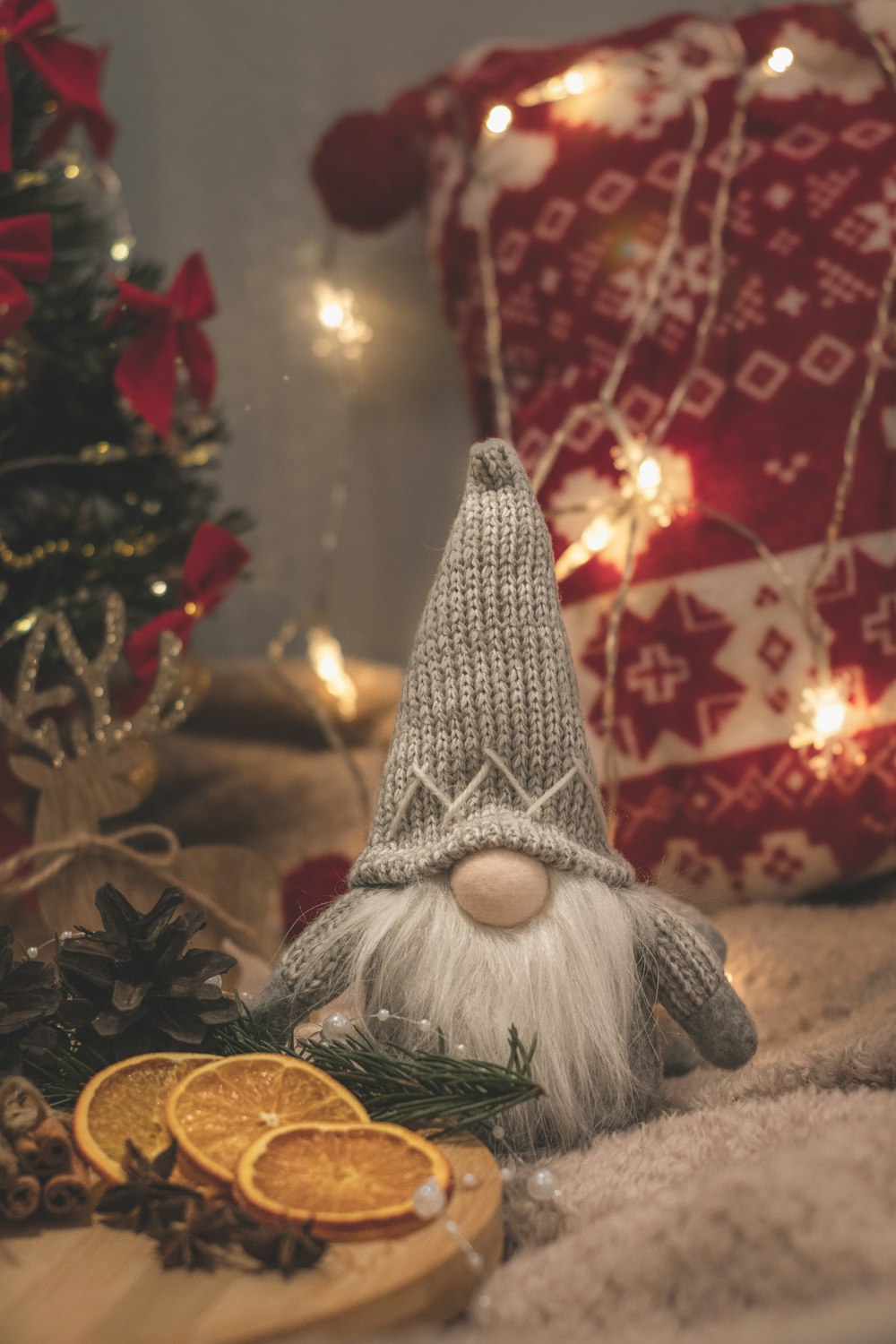 a gnome figurine sitting next to a christmas tree