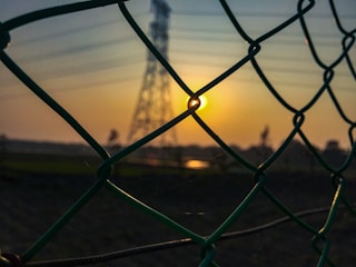 Sunset over a fenced plot ready for development.