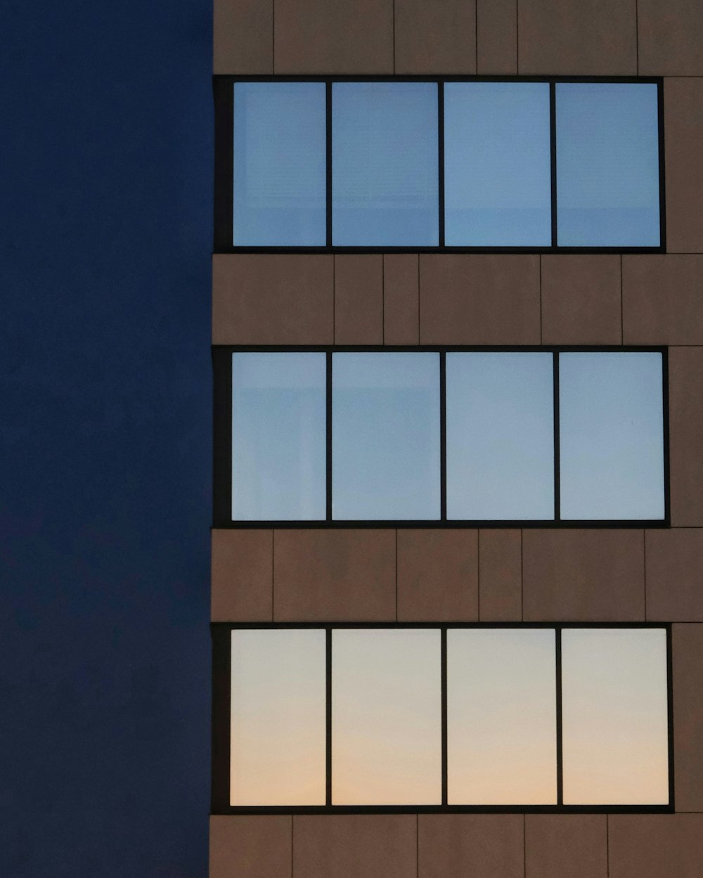 a tall building with lots of windows at night