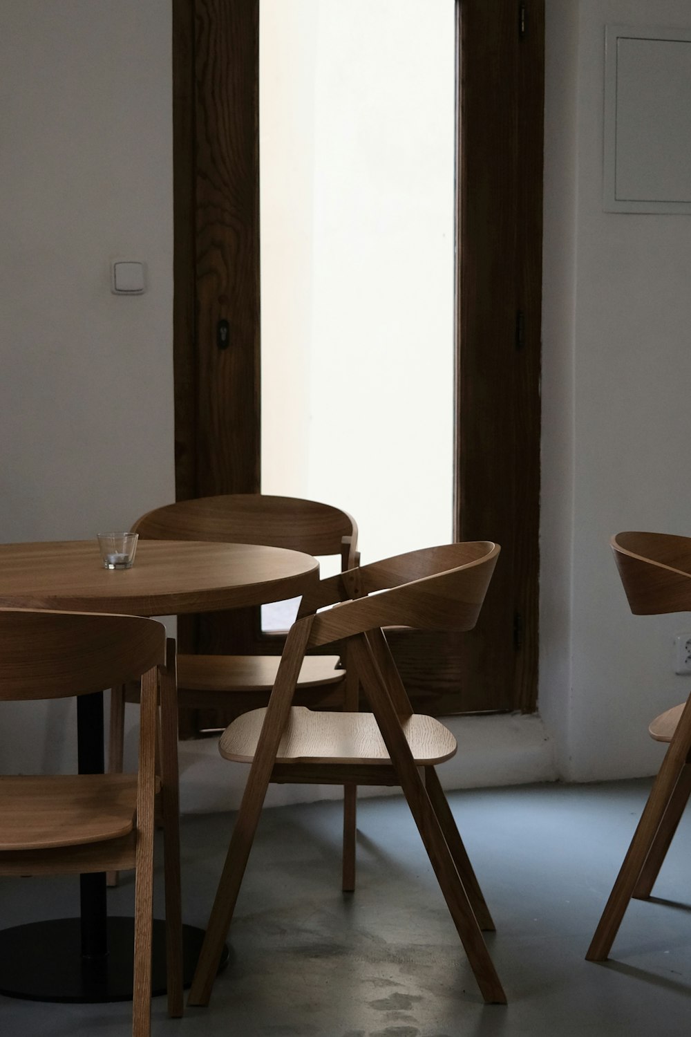 a table and chairs in a room with a window