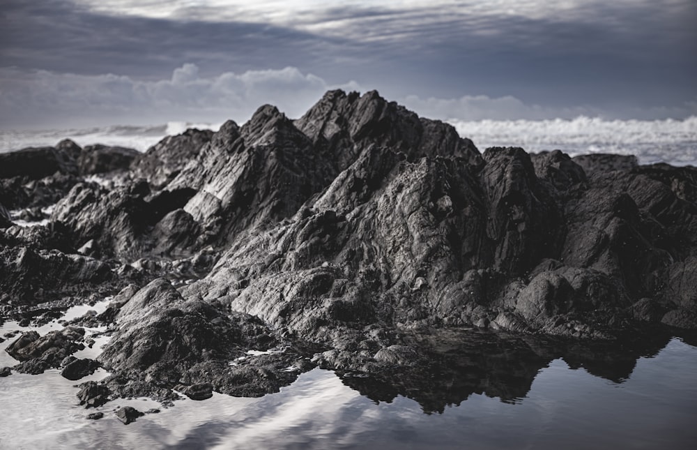 a black and white photo of some rocks and water