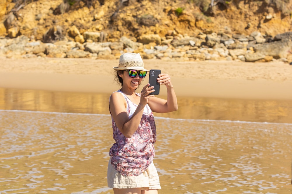 a woman taking a picture of herself in the water