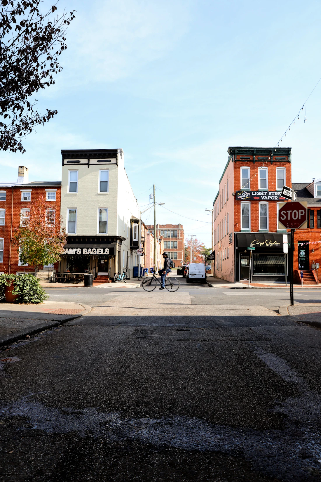 A Baltimore residential street corner with rowhouses and a stop sign