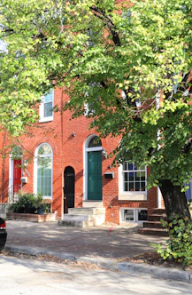 a red brick building with a green door
