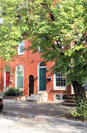 a red brick building with a green door