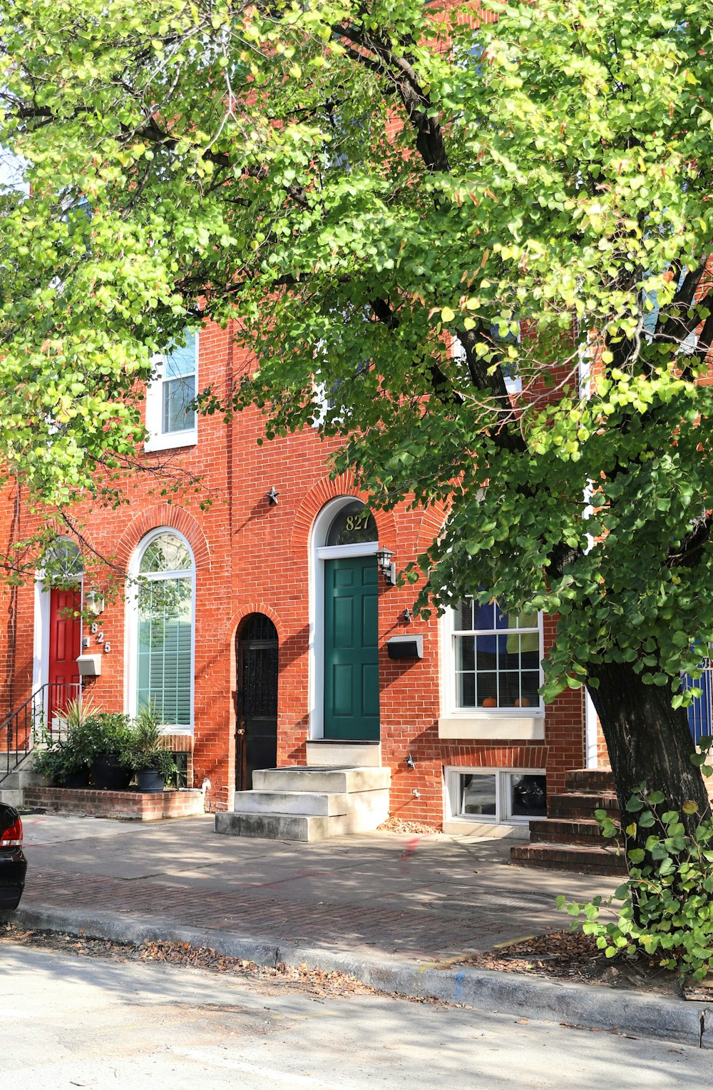 a red brick building with a green door