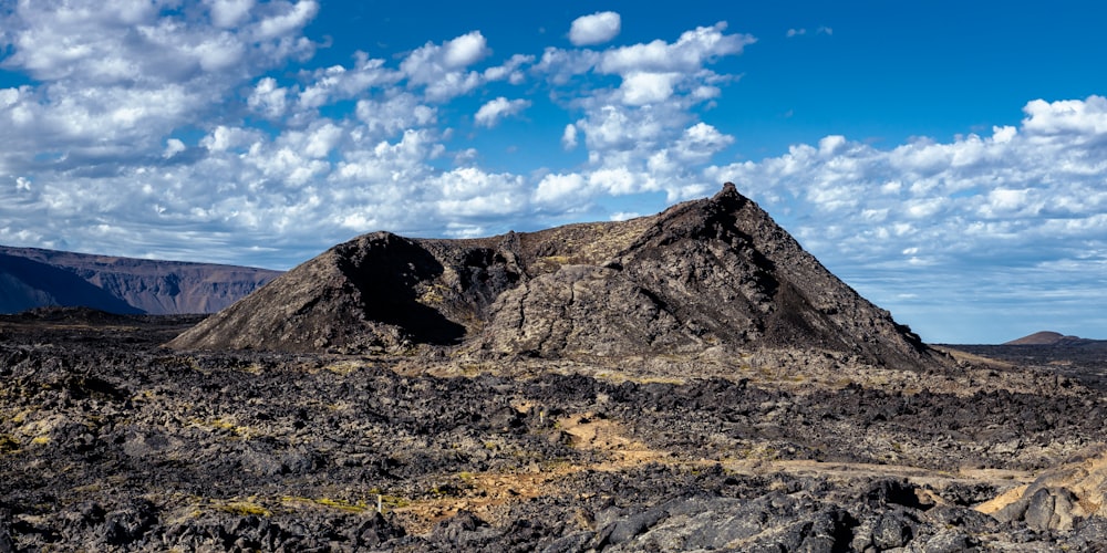 a mountain range with a dirt road in the foreground