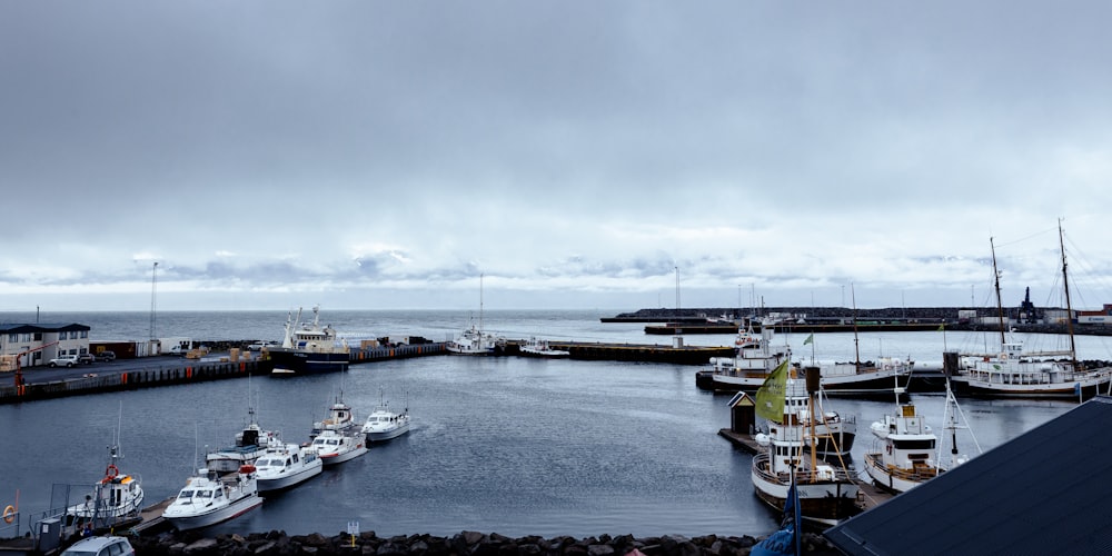 a harbor filled with lots of boats under a cloudy sky