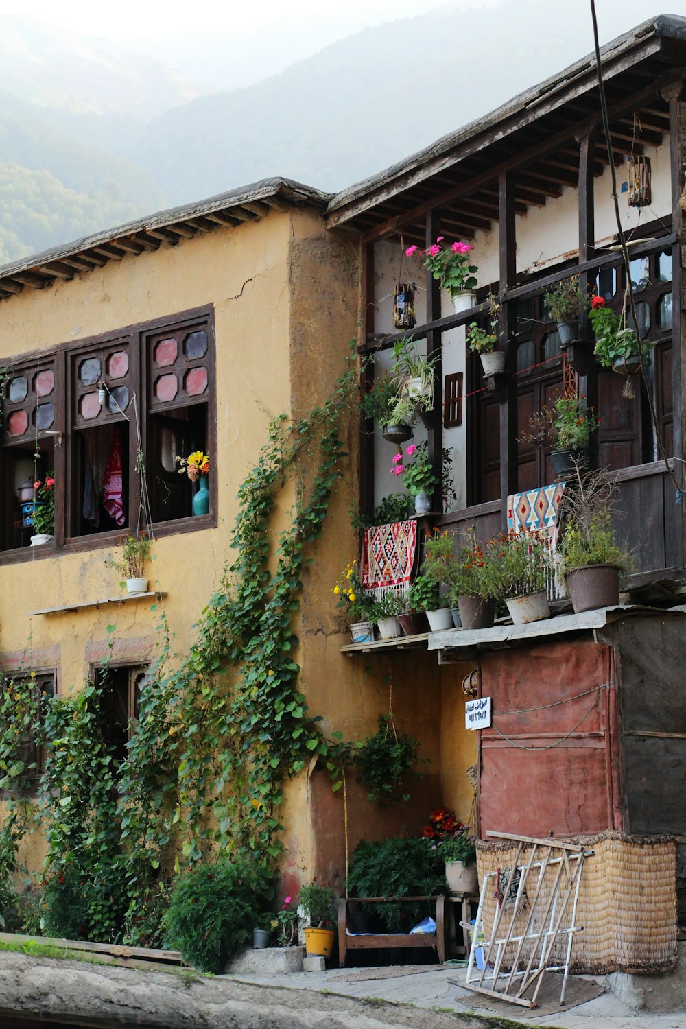 a building with a bunch of plants growing out of the windows