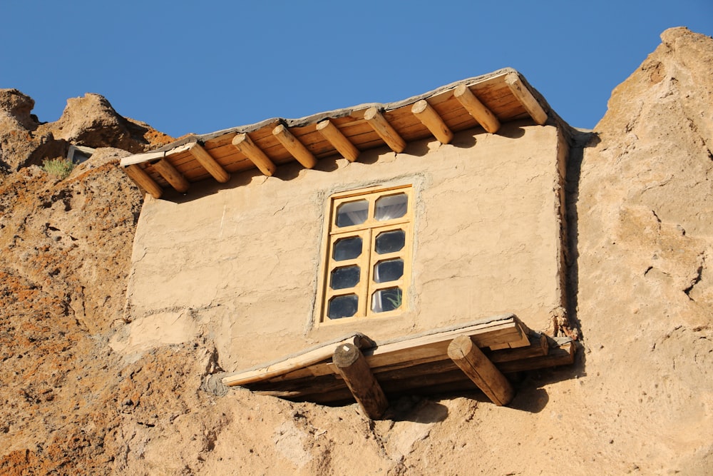 a window in a stone building with a wooden roof
