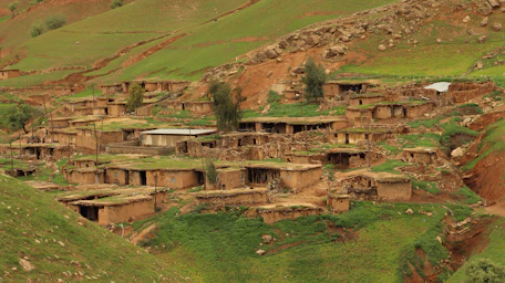 a village in the middle of a green valley