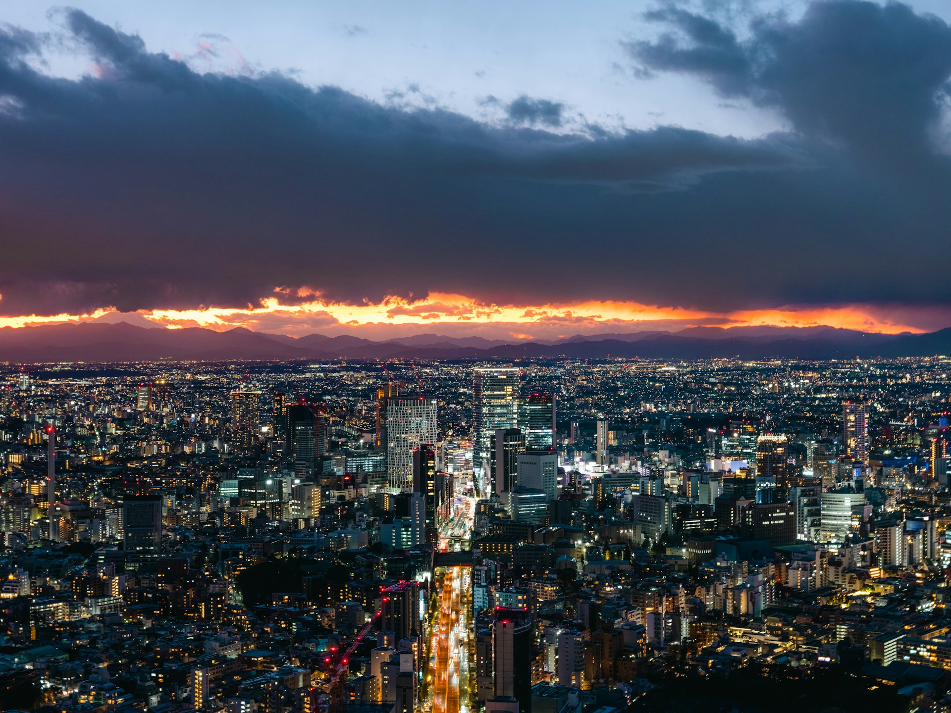 A vibrant cityscape at dusk with dynamic colors and sharp contrasts, reflecting Jeff Chatten's skill in cinematography.