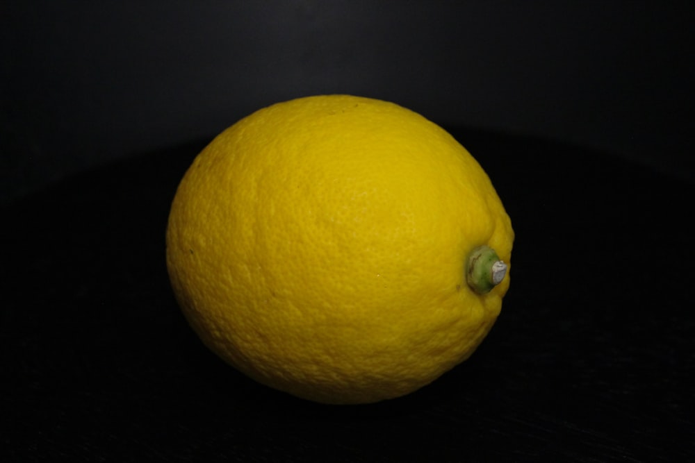 a close up of a lemon on a black background