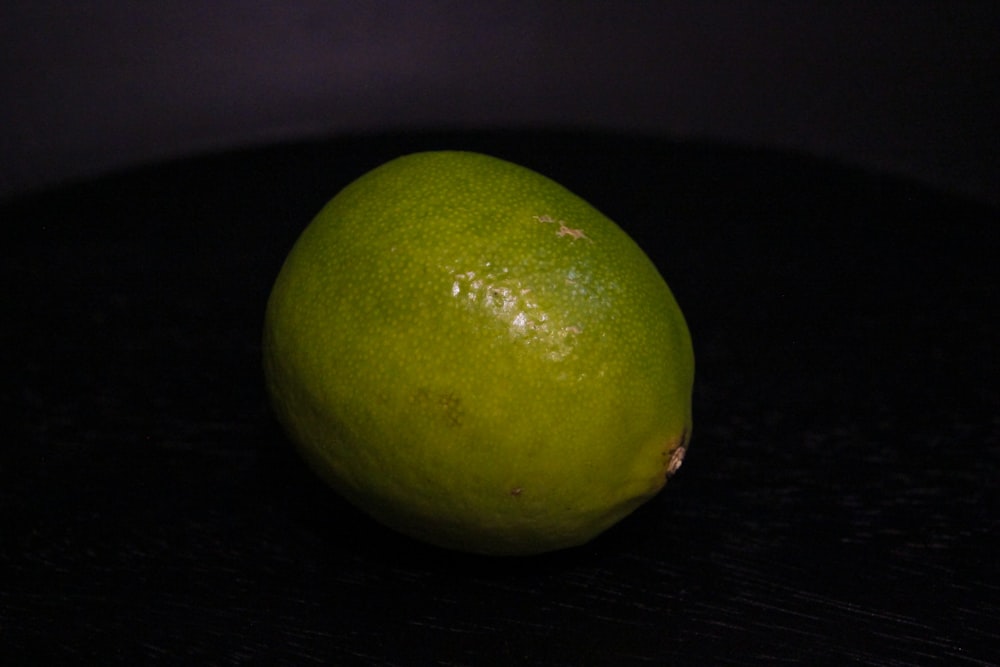 a lime sitting on top of a black table