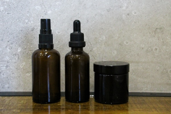 Brown glass bottles arranged on wooden surface