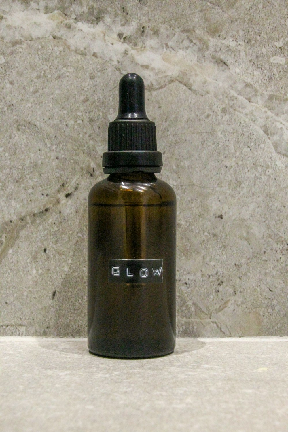 a bottle of liquid sitting on a counter