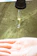 Close-up of a hand holding a translucent gelatin drop with soft natural lighting.