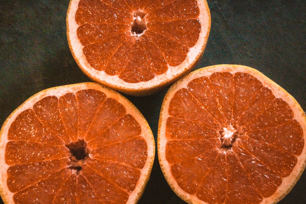 three halves of a grapefruit cut in half