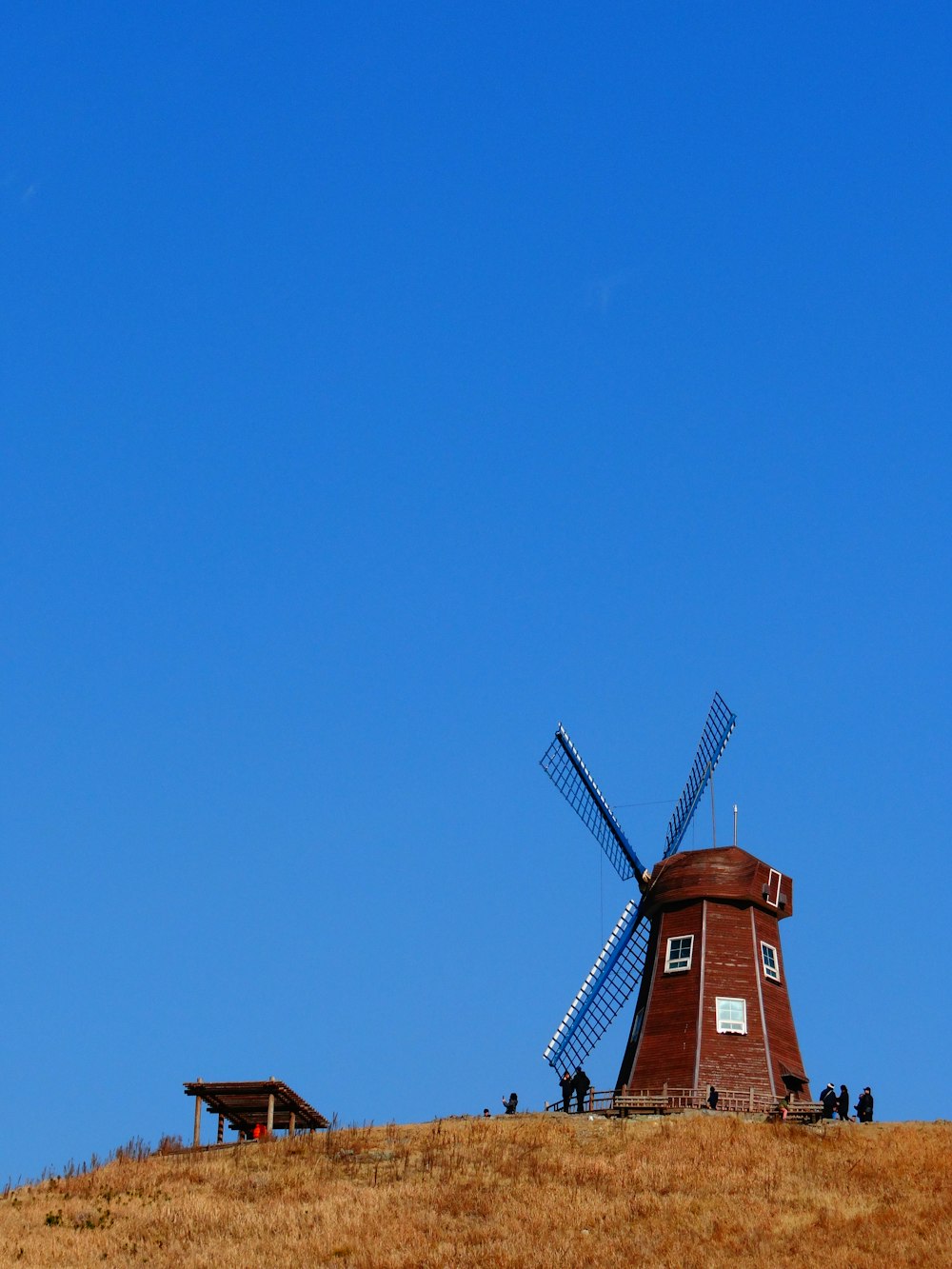 a windmill sitting on top of a hill