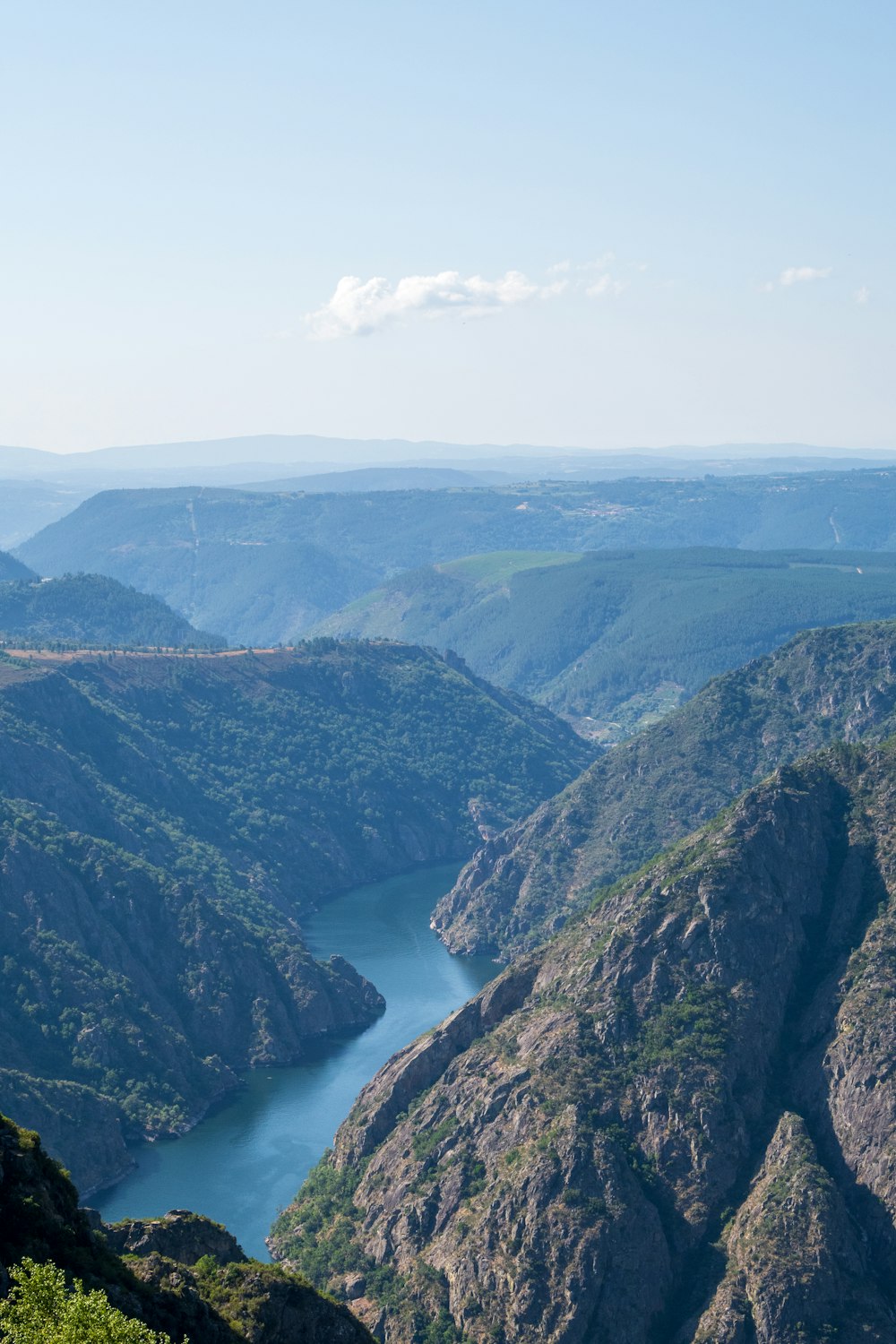 a view of a valley with a river running through it