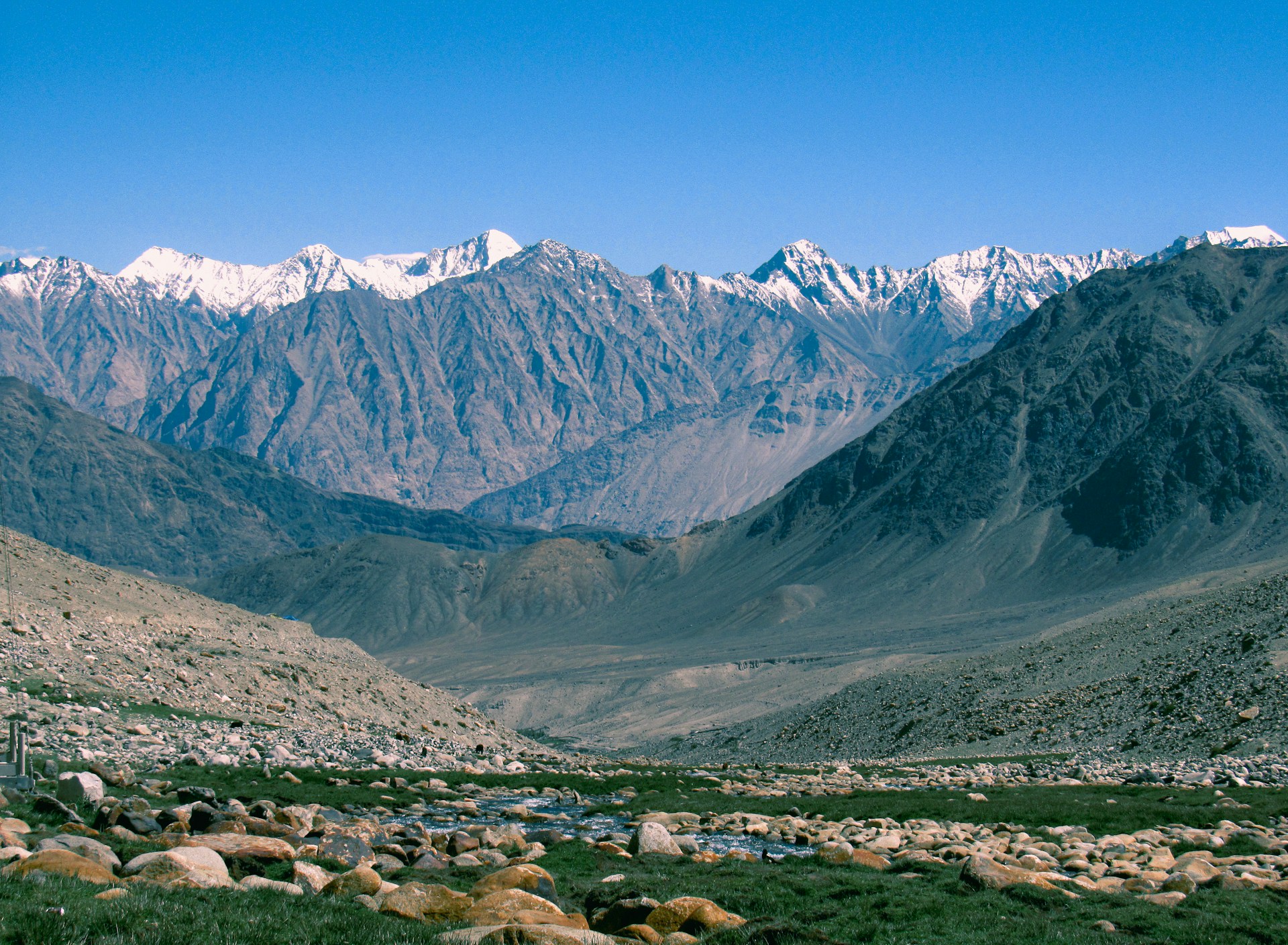 a view of a valley with mountains in the background